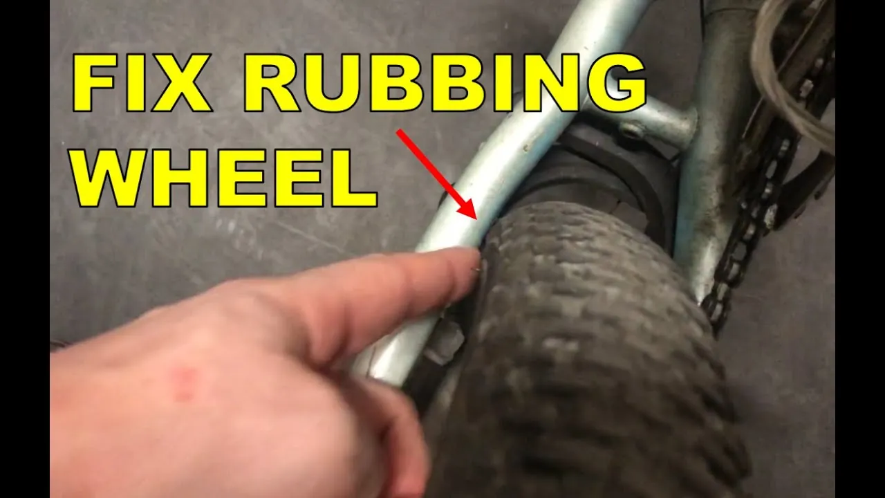 Checking for a loose bicycle axle by moving the tire side to side.