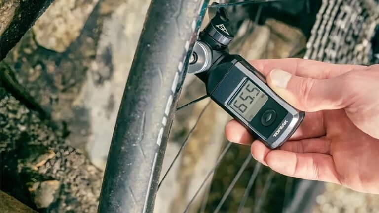 A close-up of a bicycle tire on pavement exploring how tire size affects speed.