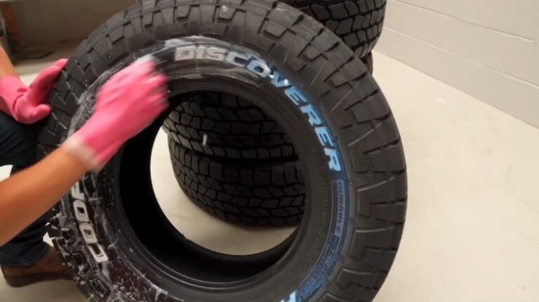 A close-up of a muddy tire showing subtle blue discoloration on the sidewall.