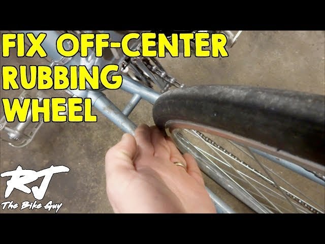 Close up view of a bicycle tire near the frame in a workshop.