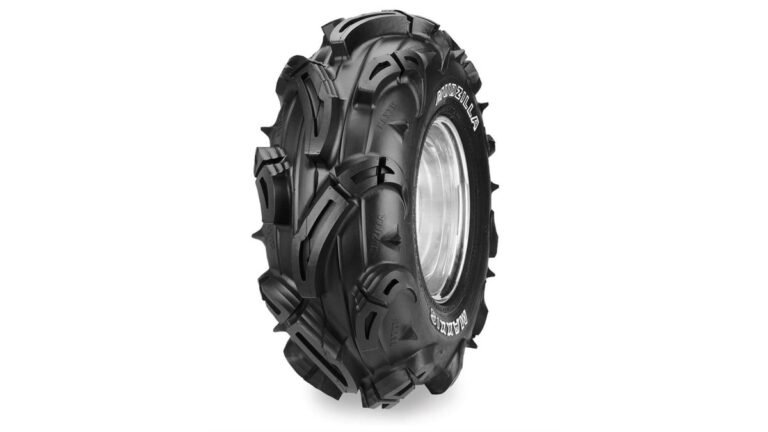 A rugged ATV parked on a muddy trail showcasing lightweight mud tires.