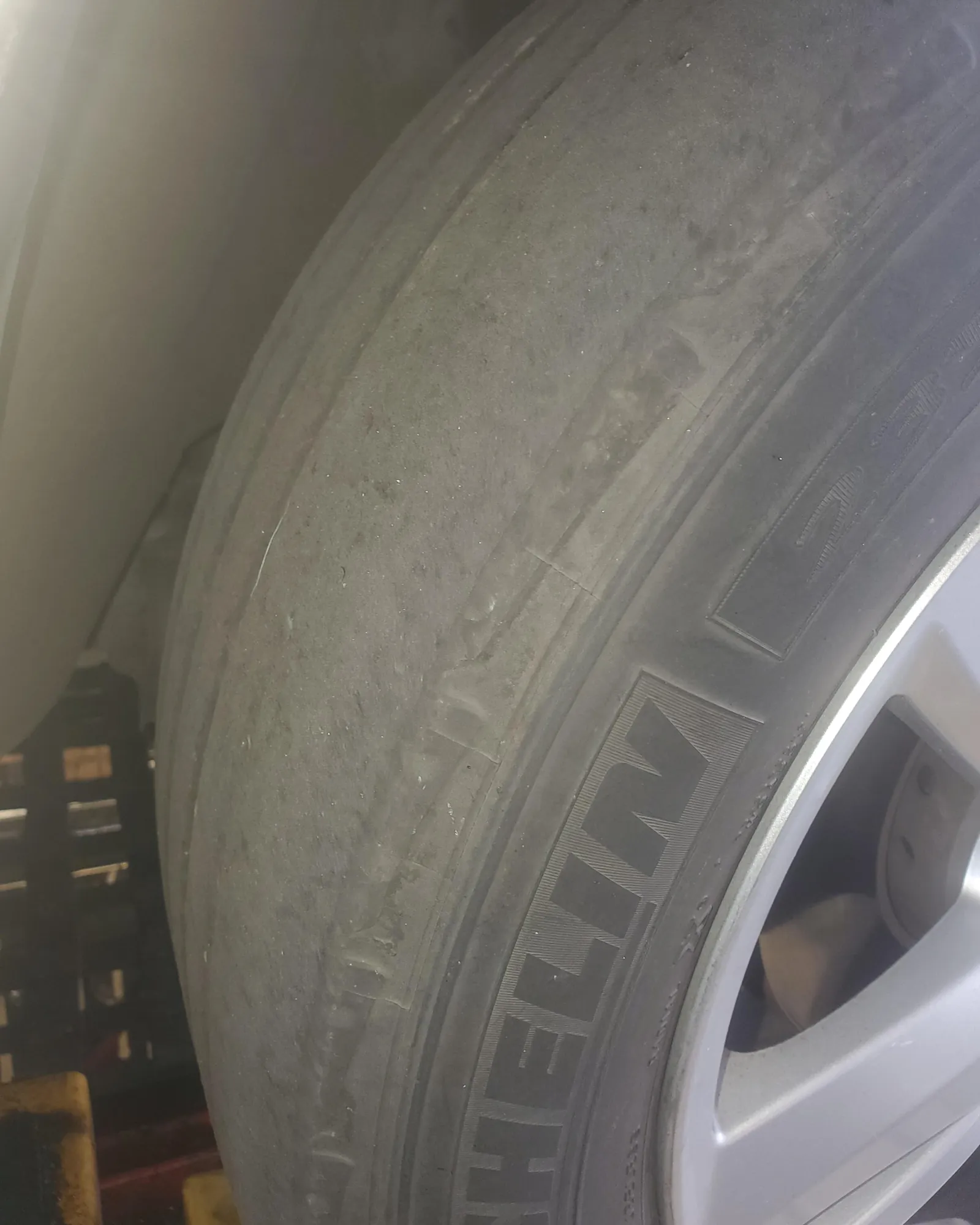 A service advisor confirms vehicle maintenance services while holding an owner's manual.