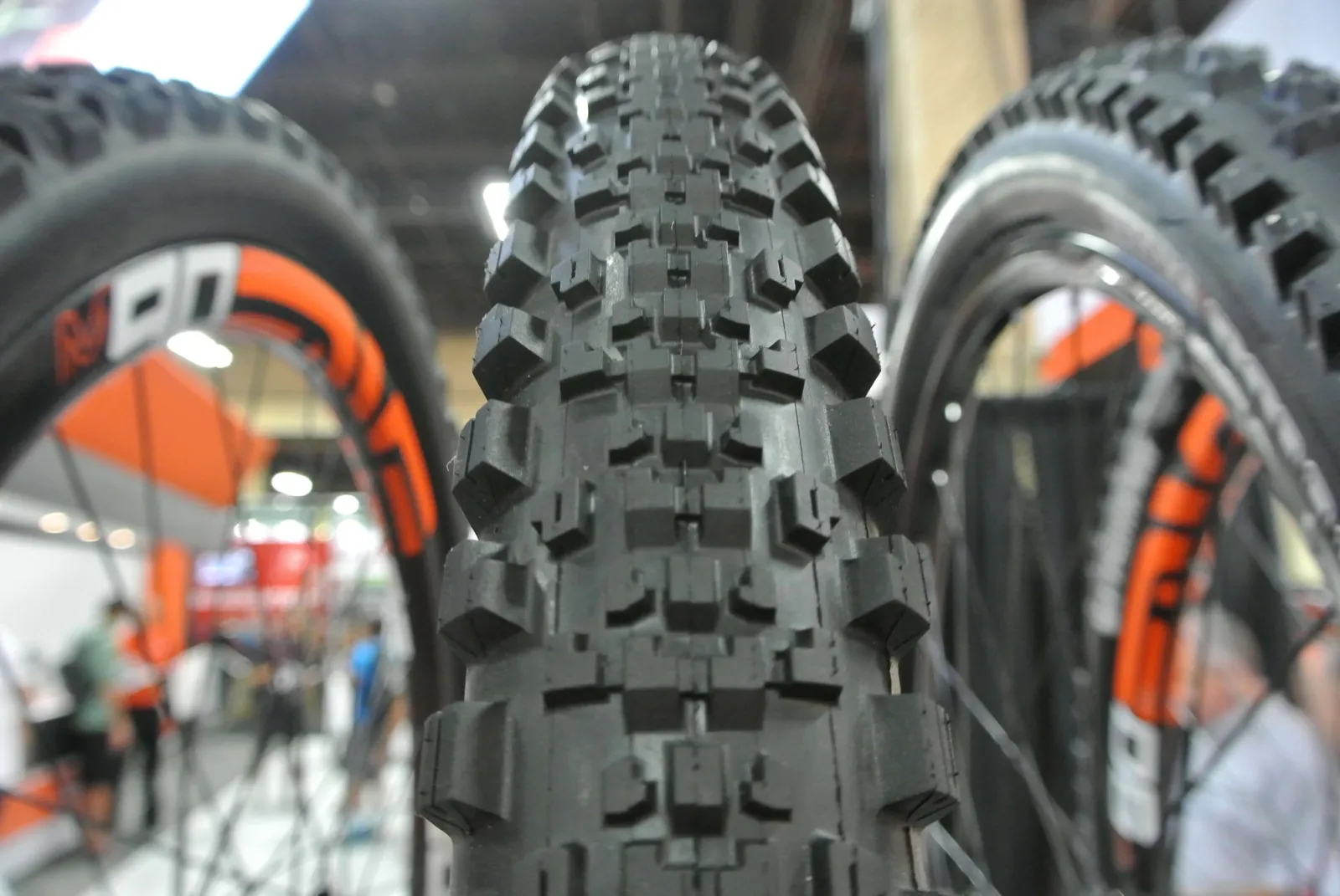 Three different bicycle tire widths lined up on a workbench to compare performance.